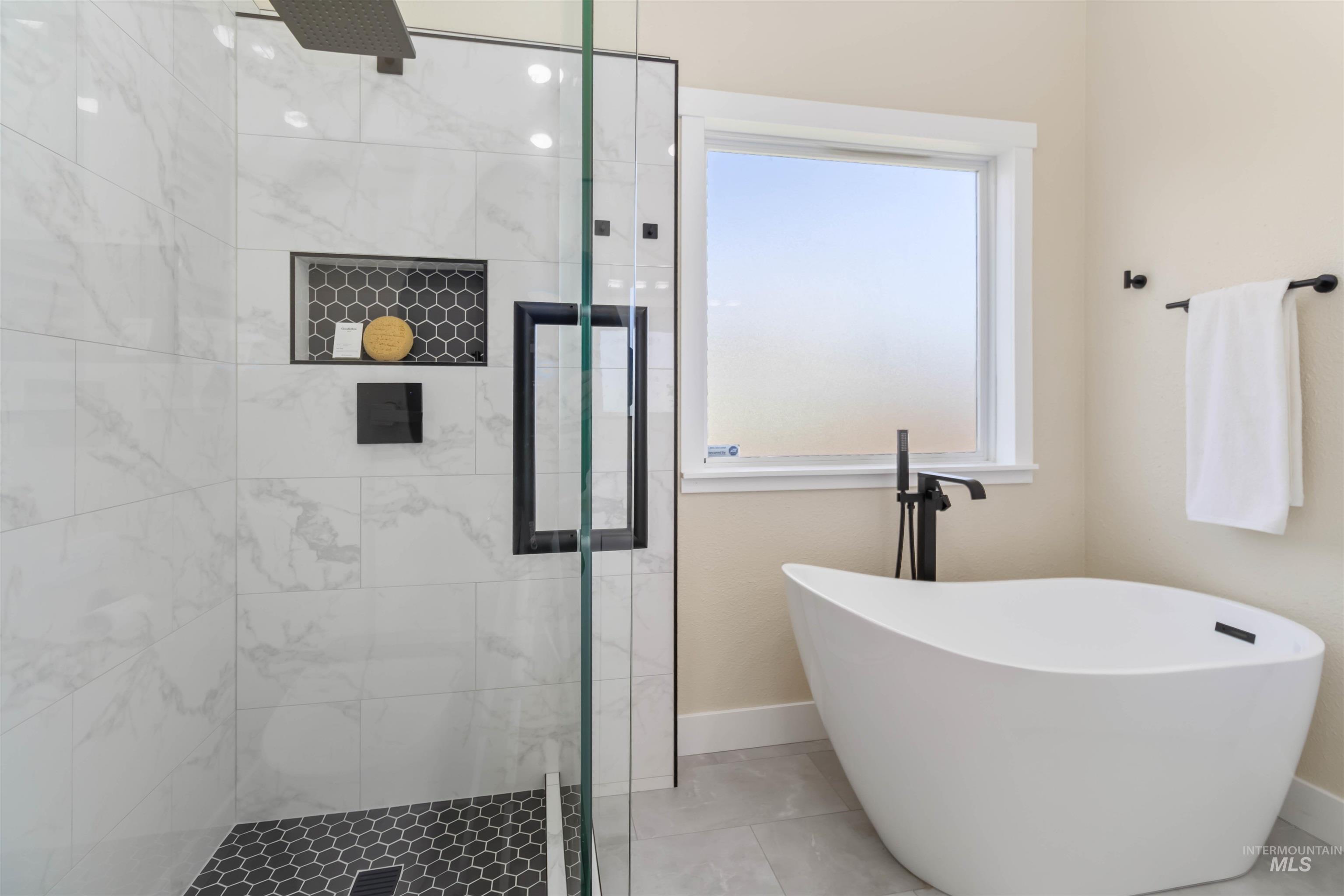 3201 Raintree Drive Nampa, ID 83686 - Photo 21 of 50 Full bath featuring a stall shower, a freestanding bath, and tile patterned floors