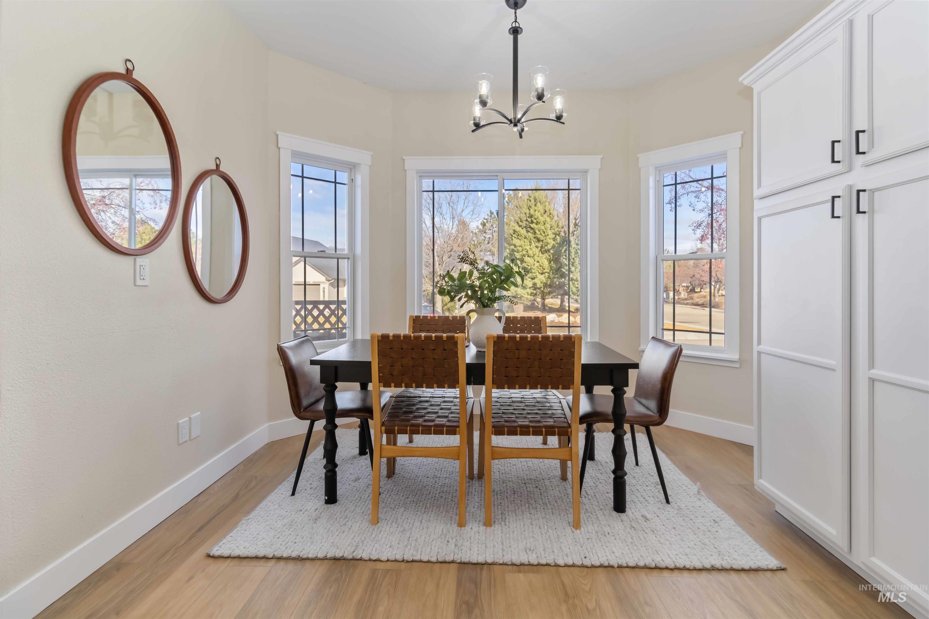 3201 Raintree Drive Nampa, ID 83686 - Photo 31 of 50 Dining space with light wood-style floors and a chandelier