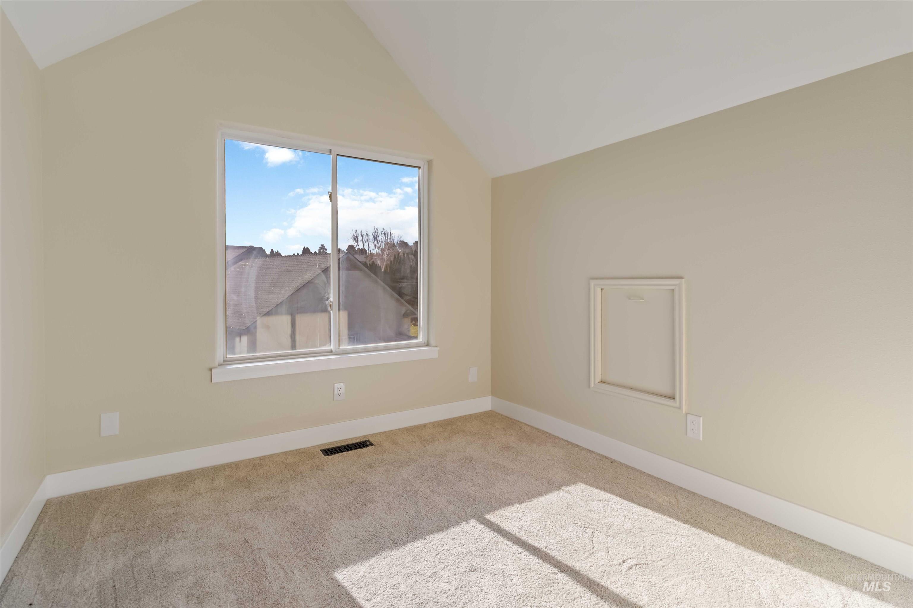 3201 Raintree Drive Nampa, ID 83686 - Photo 44 of 50 Carpeted spare room with vaulted ceiling and baseboards