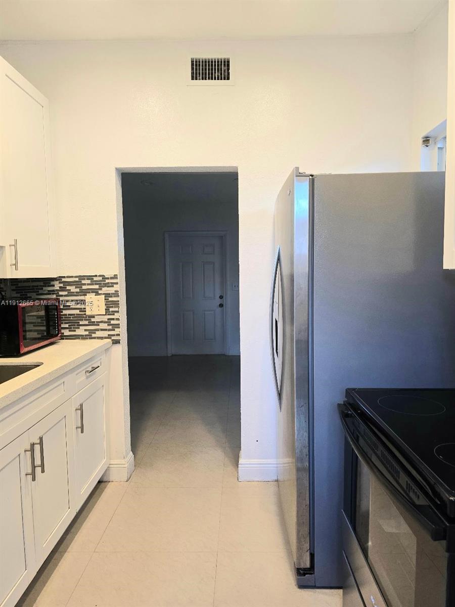 a kitchen with stainless steel appliances a refrigerator and a stove