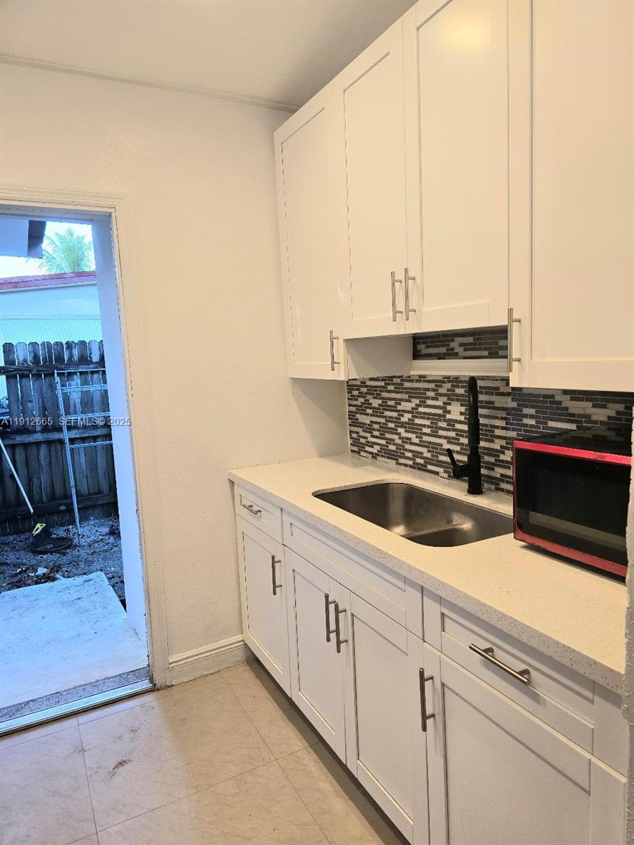 3621 Southwest 47th Avenue West Park, FL 33023 - Photo 2 of 10 a kitchen with a sink and a washing machine