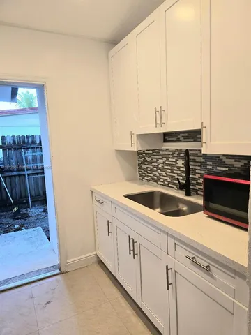 a kitchen with a sink and a washing machine