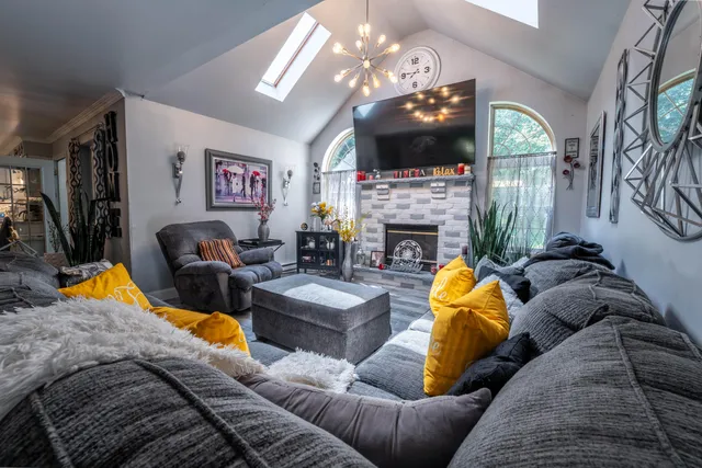 a living room with furniture a fireplace and a flat screen tv