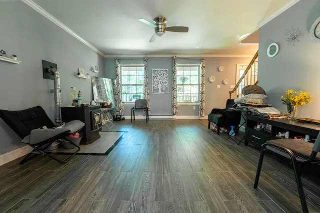 a living room with furniture and wooden floor