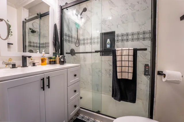 a bathroom with a sink toilet and shower