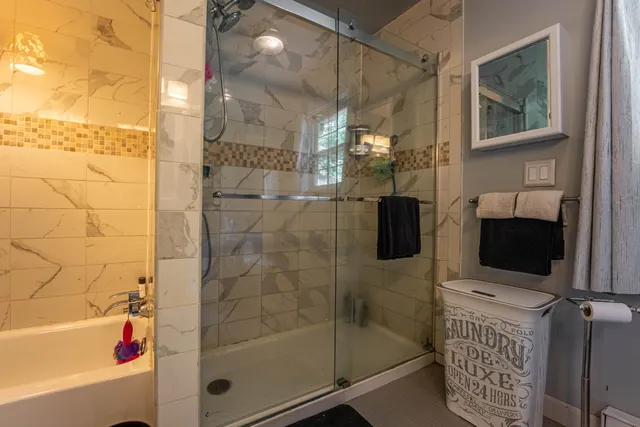 a bathroom with a shower and a bathtub