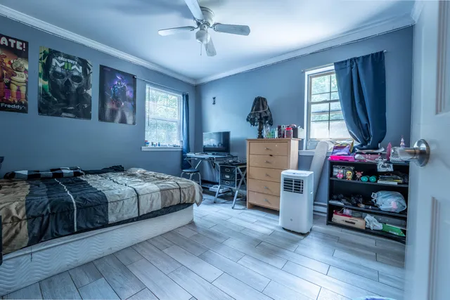 a bedroom with bed and a window