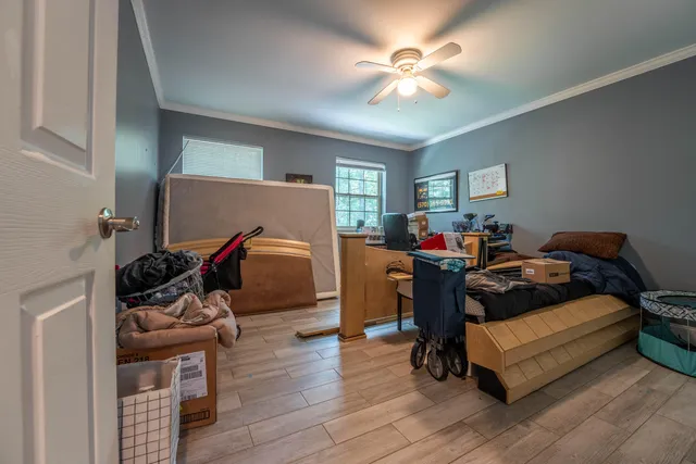 a bedroom with furniture and a wooden floor