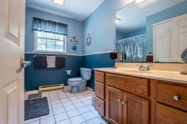 a bathroom with a sink toilet and mirror