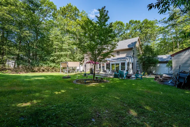 a view of a house with a yard porch and sitting area