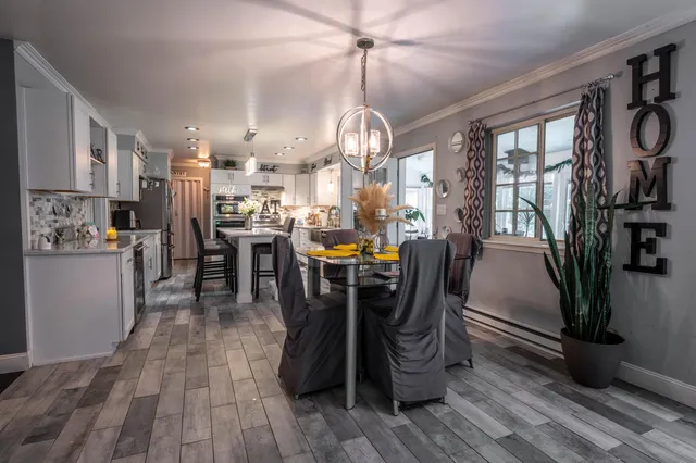 a view of a dining room with furniture window and wooden floor