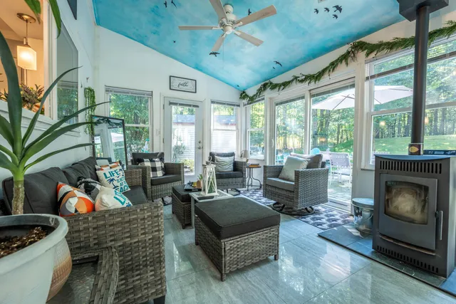 a living room with furniture fireplace and flat screen tv