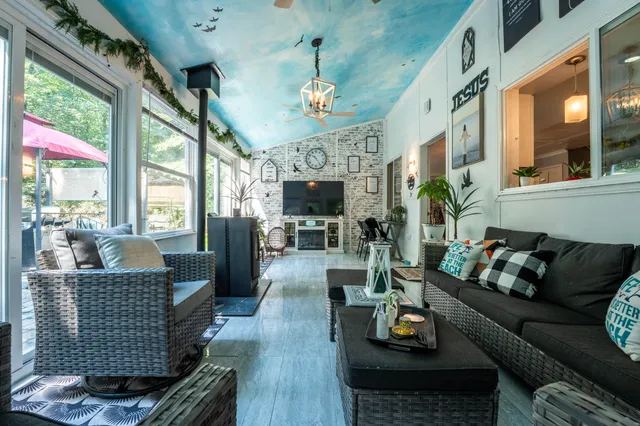a living room with furniture fireplace and flat screen tv