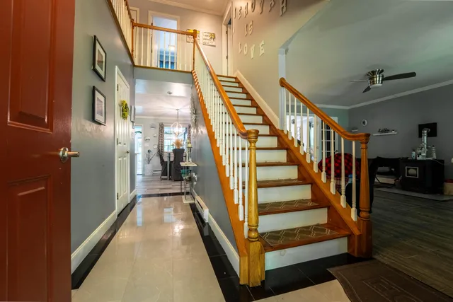 a view of entryway and hall with wooden floor