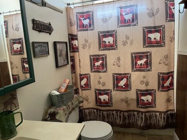 a bedroom with a bed and a wooden floor