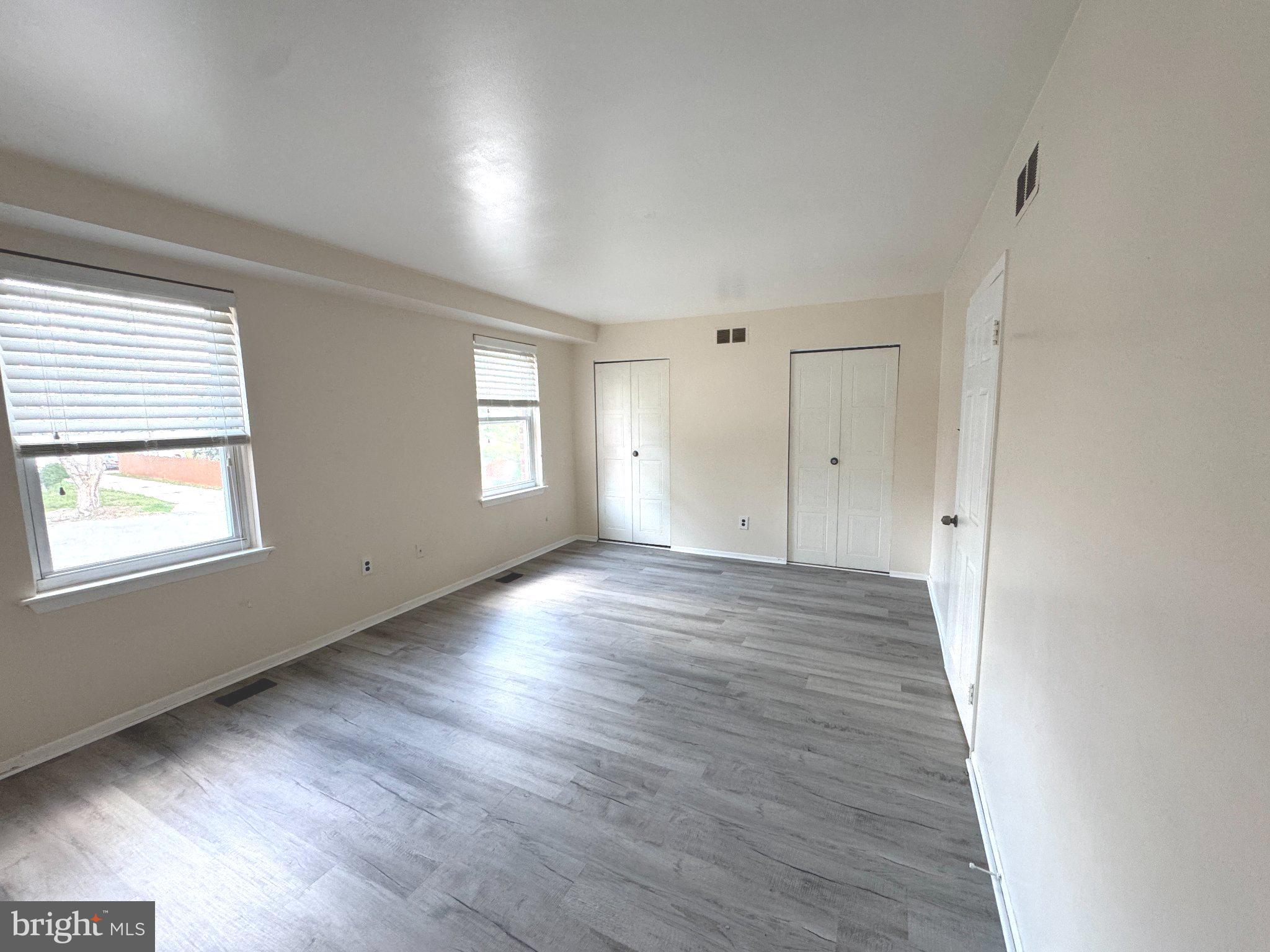 12044 Abby Road, Unit 1 Philadelphia, PA 19154 - Photo 6 of 10 an empty room with wooden floor and window