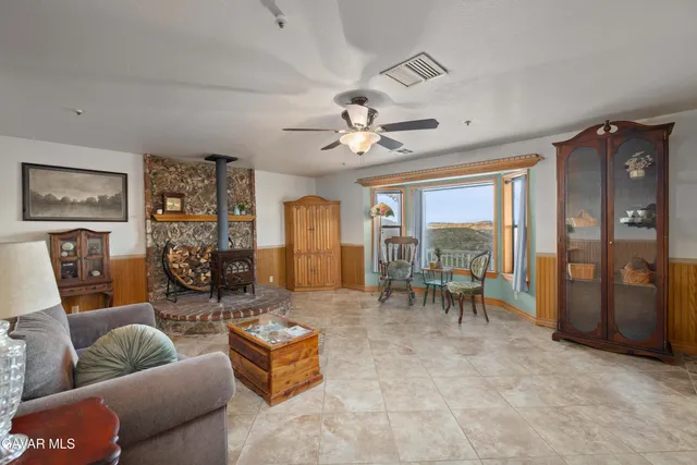 a living room with furniture and a kitchen view