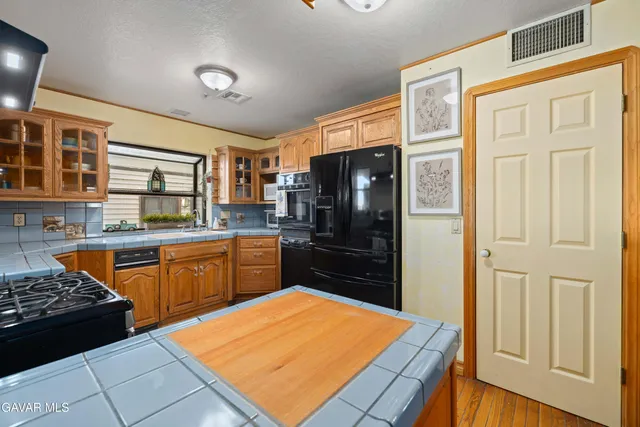 a kitchen with stainless steel appliances granite countertop a stove and a refrigerator