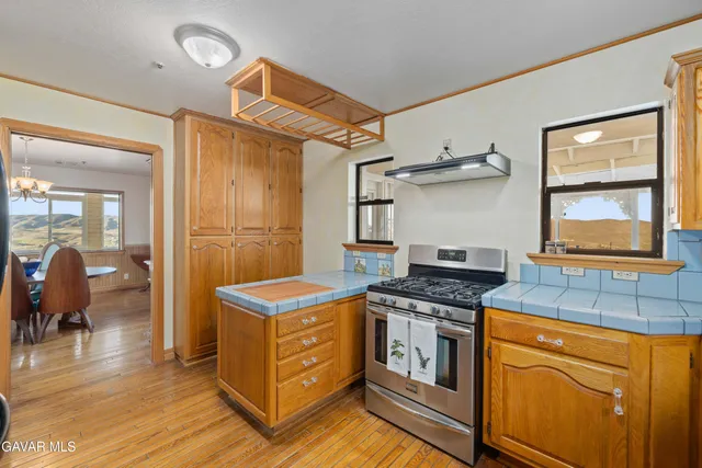 a kitchen with stainless steel appliances granite countertop a refrigerator and a stove