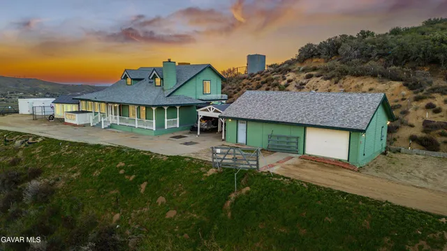 a front view of a house with a garden and yard