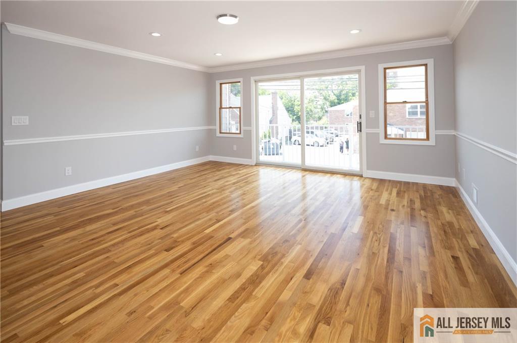 278 Rector Street Perth Amboy, NJ 08861 - Photo 14 of 47 an empty room with wooden floor and windows