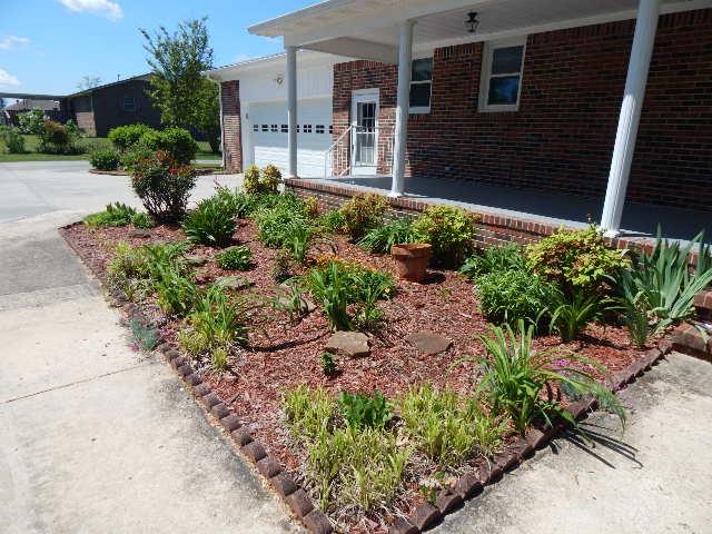 820 Spring Valley Road McMinnville, TN 37110 - Photo 3 of 30 Lovingly maintained flower bed off the back covered porch. Concrete drive plus lots of parking .