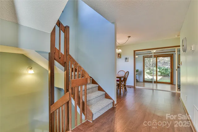 a view of entryway and hall with wooden floor