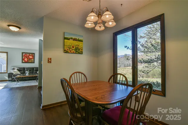 a view of a dining room with furniture wooden floor and chandelier
