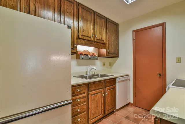 a kitchen with a sink and a refrigerator