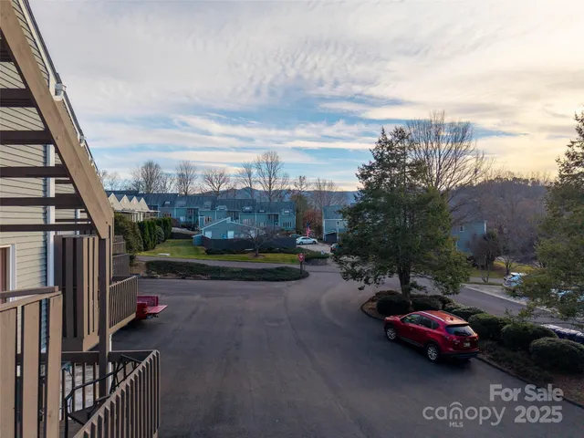 a view of a street with cars parked