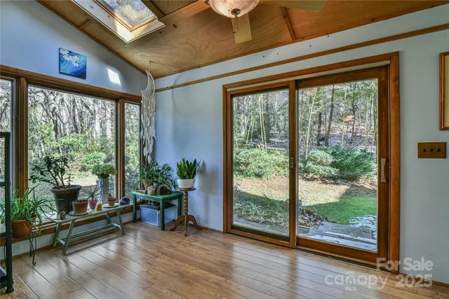 a view of a livingroom with furniture wooden floor and front door