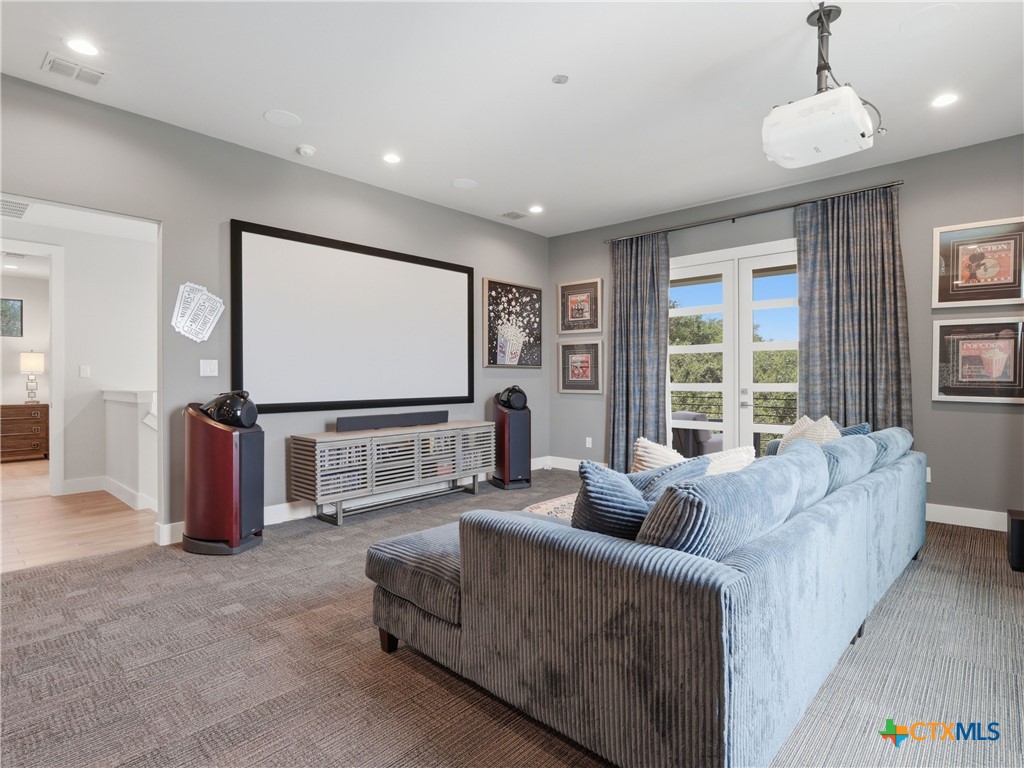 5913 Verden Ridge New Braunfels, TX 78132 - Photo 28 of 48 a living room with furniture a projector and a flat screen tv