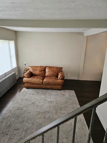 a view of a chandelier fan and wooden floor