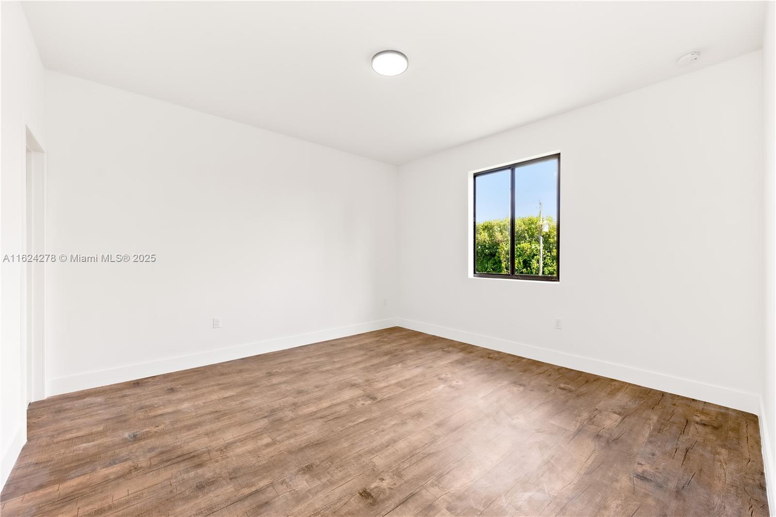 866 Southwest 1st Street Florida City, FL 33034 - Photo 21 of 52 an empty room with a window