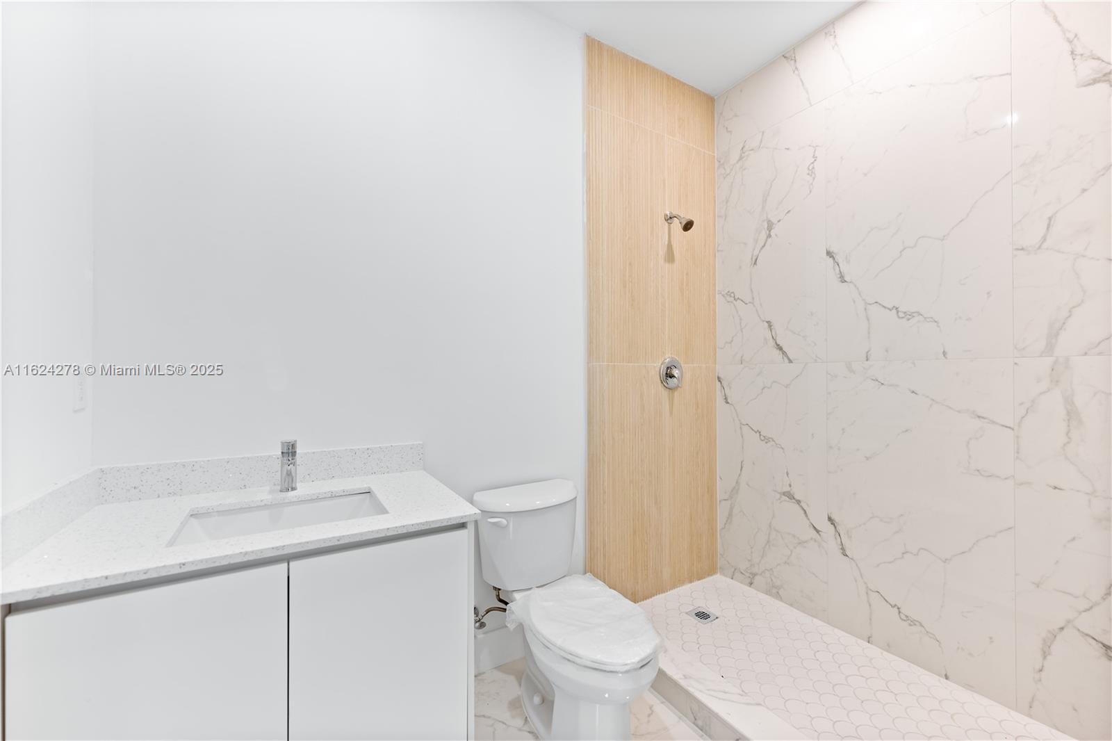 866 Southwest 1st Street Florida City, FL 33034 - Photo 42 of 52 a bathroom with a toilet a sink a mirror and vanity