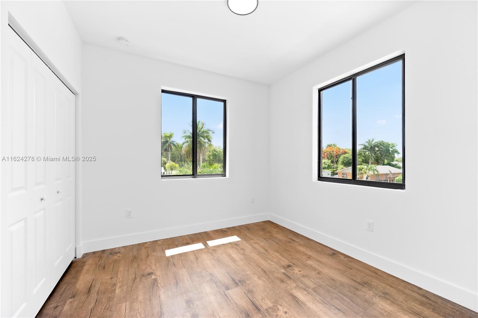 866 Southwest 1st Street Florida City, FL 33034 - Photo 45 of 52 an empty room with wooden floor and windows
