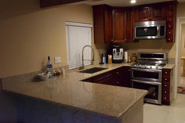 a kitchen with sink a microwave and stove