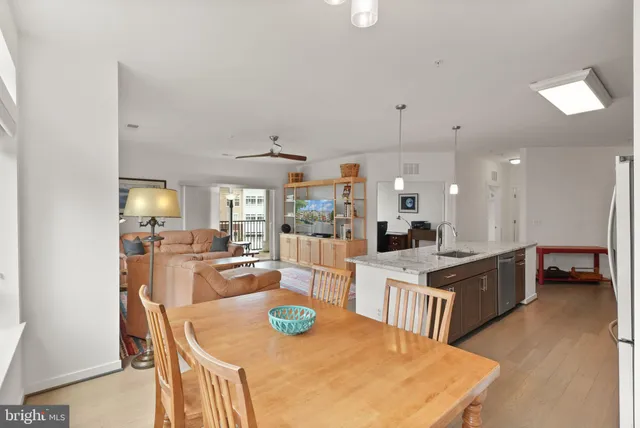 a large kitchen with kitchen island a large counter top appliances and furniture