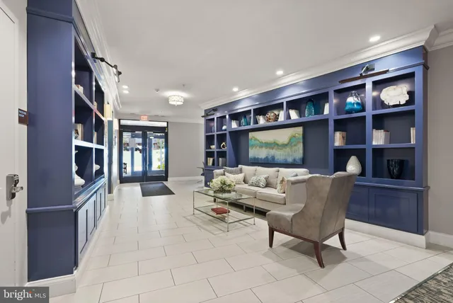 a living room with furniture a bookshelf and a book shelf