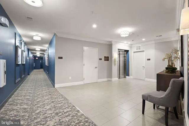a view of a hallway with furniture