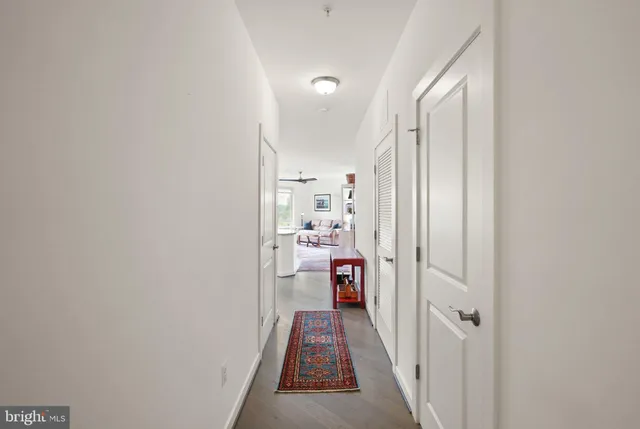 a view of a hallway with a livingroom and furniture