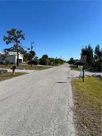 a view of a dirt road with a building in the background