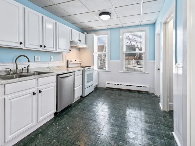 a kitchen with granite countertop a sink stainless steel appliances and cabinets