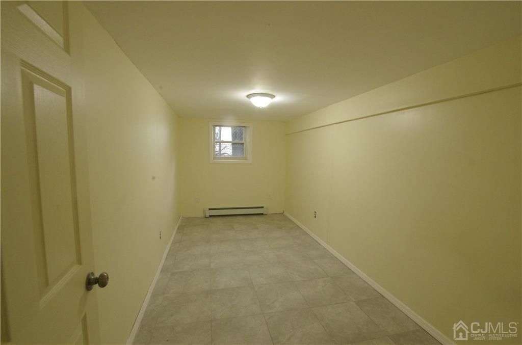 127 Blair Road Port Reading, NJ 07064 - Photo 14 of 17 an empty room with a empty space and a window