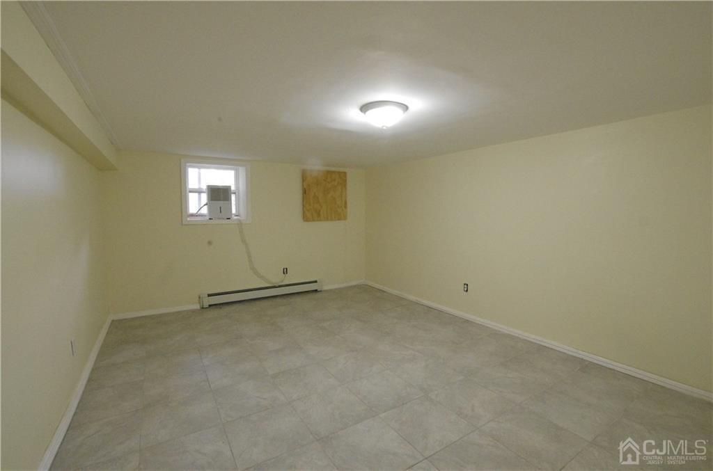 127 Blair Road Port Reading, NJ 07064 - Photo 15 of 17 an empty room with windows