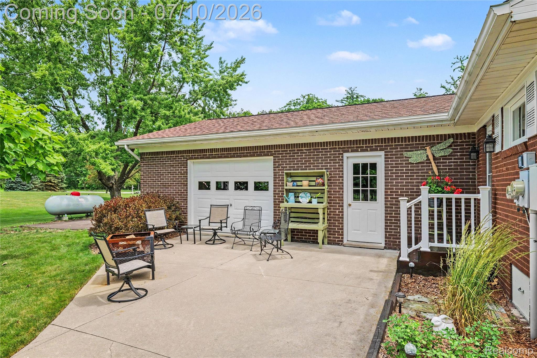 2180 Hurst Road St. Clair, MI 48079 - Photo 28 of 39 Concrete patio area featuring a brick exterior and white garage door