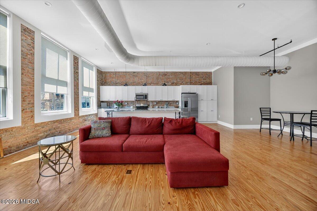 565 Poplar Street Macon, GA 31201 - Photo 3 of 12 a living room with furniture and a wooden floor