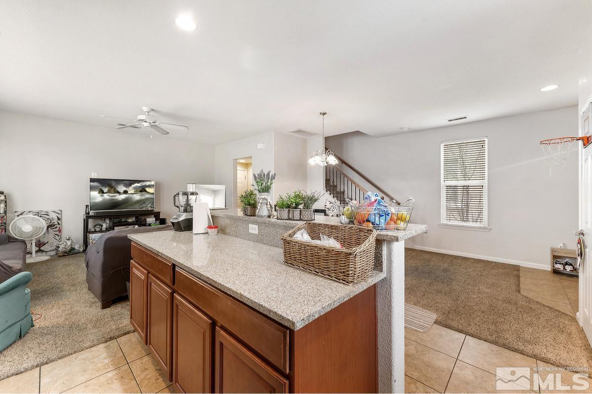 2020 Alamo Square Way Reno, NV 89509 - Photo 12 of 23 a kitchen with stainless steel appliances granite countertop a sink a stove and a refrigerator