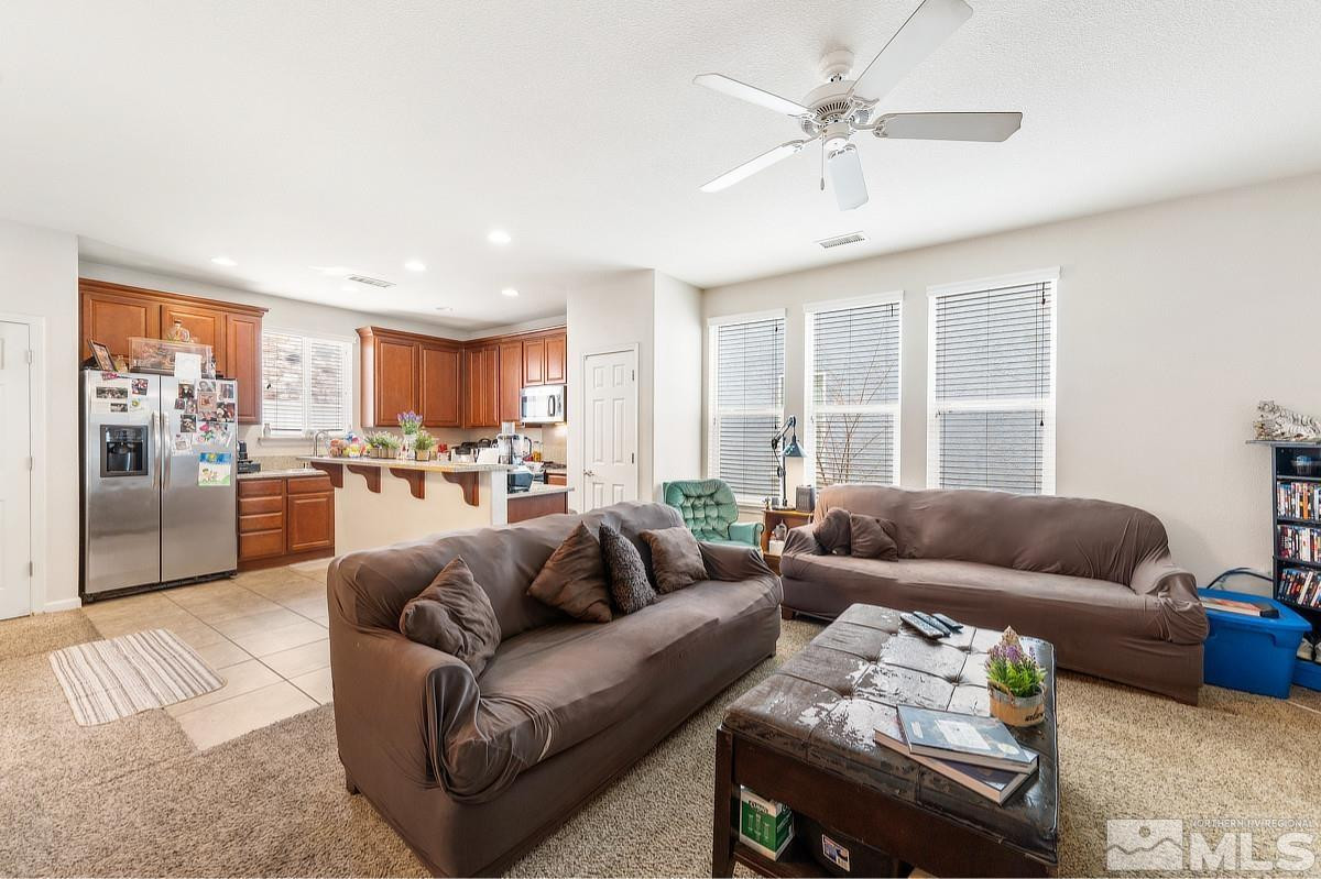 2020 Alamo Square Way Reno, NV 89509 - Photo 9 of 23 a living room with furniture and a large window with kitchen view