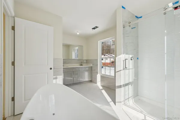 a spacious bathroom with a granite countertop sink mirror and